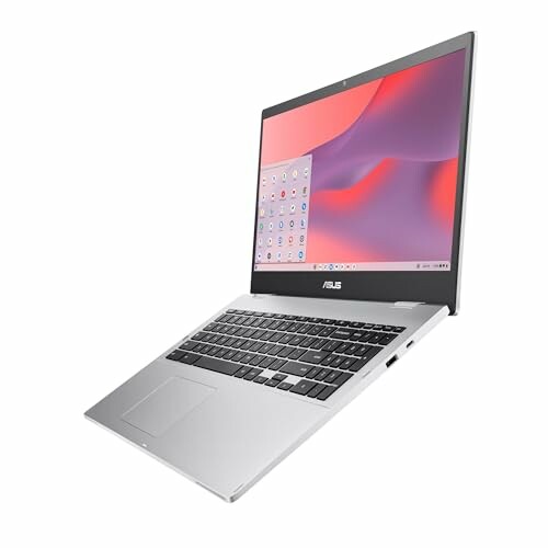 Silver Asus laptop with open screen displaying a colorful background.